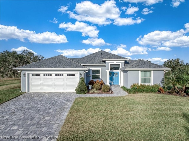 view of front of house featuring a front yard and a garage