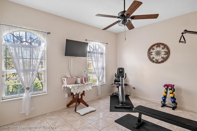 workout area with ceiling fan, light tile patterned floors, and a wealth of natural light