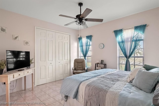 bedroom featuring a closet, ceiling fan, and light tile patterned flooring