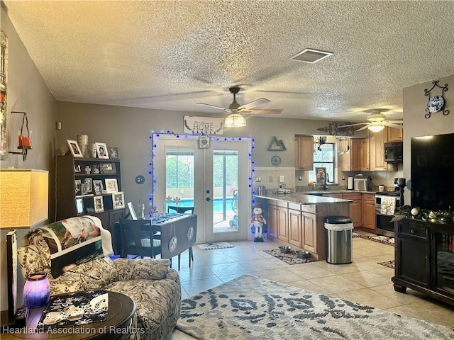 kitchen with french doors, sink, light tile patterned floors, double oven range, and ceiling fan