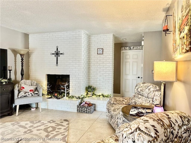 living room featuring light tile patterned flooring, a brick fireplace, and a textured ceiling