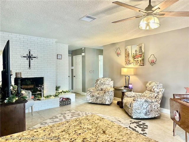 living room with tile patterned flooring, a textured ceiling, a fireplace, and ceiling fan