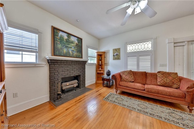 living room with light hardwood / wood-style flooring and ceiling fan