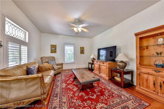 living room with ceiling fan and wood-type flooring