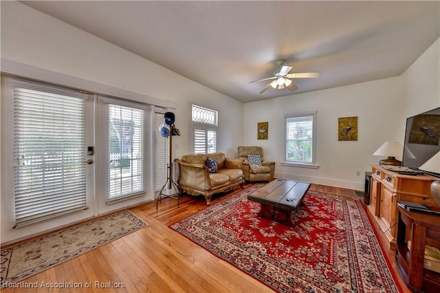 living room with hardwood / wood-style floors and ceiling fan