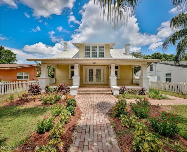 view of front of property with covered porch and french doors