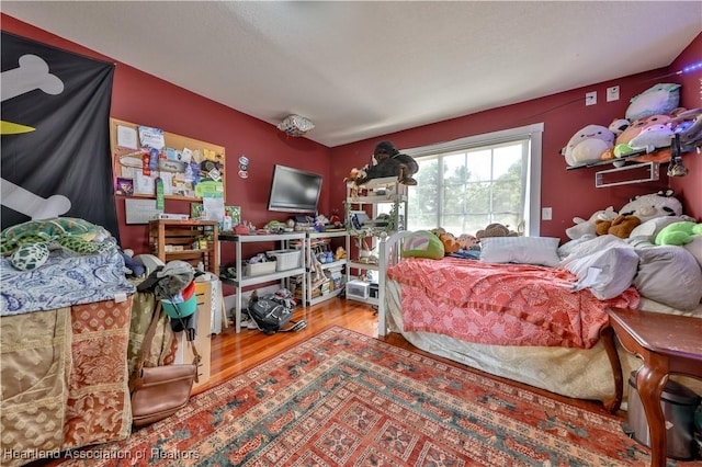 bedroom with hardwood / wood-style floors