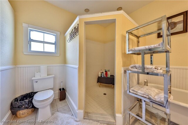 bathroom with tile patterned floors, a bathtub, and toilet