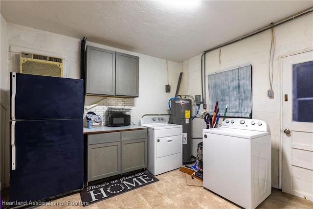 laundry area featuring water heater, an AC wall unit, washer and clothes dryer, and cabinet space