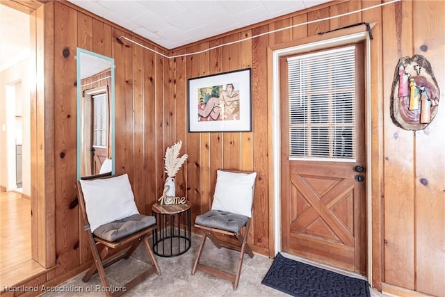 living area featuring wooden walls