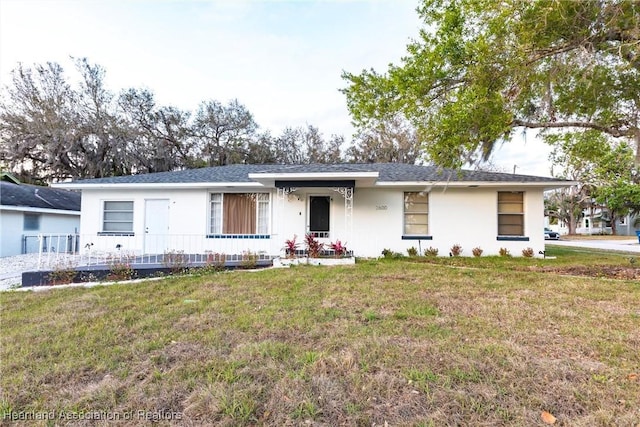 ranch-style home featuring a porch and a front lawn