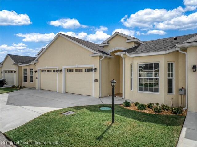 view of front of home with a garage and a front yard