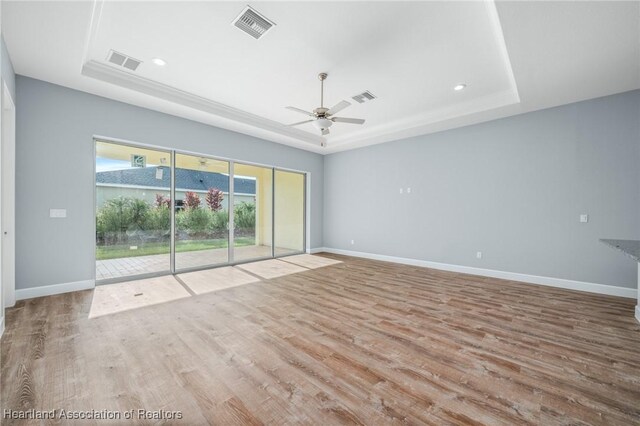 35151 Daily Dr, Sebring, FL 33872 - unfurnished room featuring a raised ceiling, ceiling fan, and light wood-type flooring
