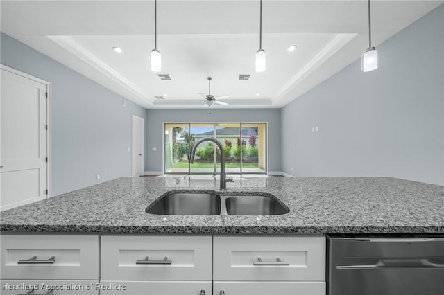 35151 Daily Dr, Sebring, FL 33872 - kitchen featuring ceiling fan, sink, a raised ceiling, pendant lighting, and white cabinets