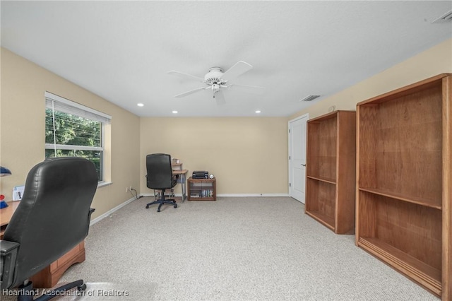 carpeted office featuring ceiling fan