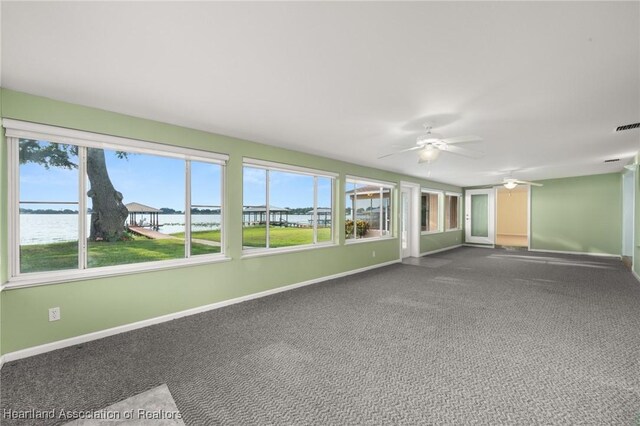 unfurnished sunroom featuring a water view