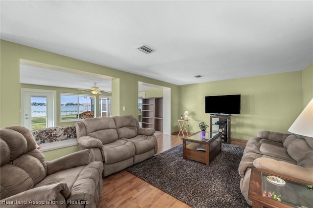 living room with ceiling fan and hardwood / wood-style floors