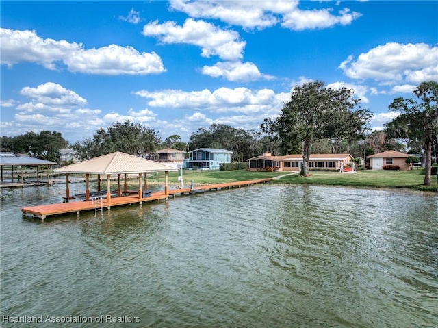 view of dock featuring a yard and a water view