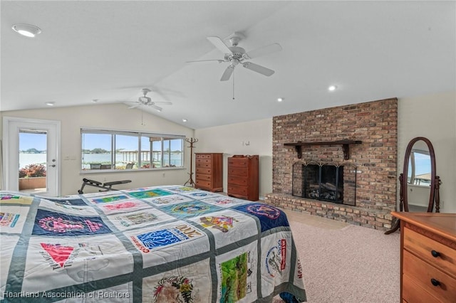 bedroom with ceiling fan, lofted ceiling, carpet, and a fireplace