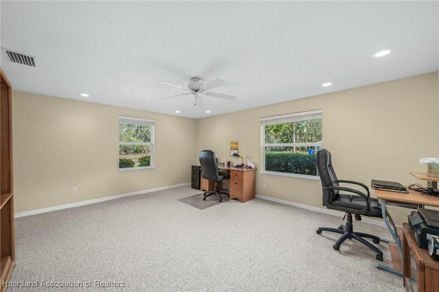 office area with ceiling fan, light colored carpet, and plenty of natural light