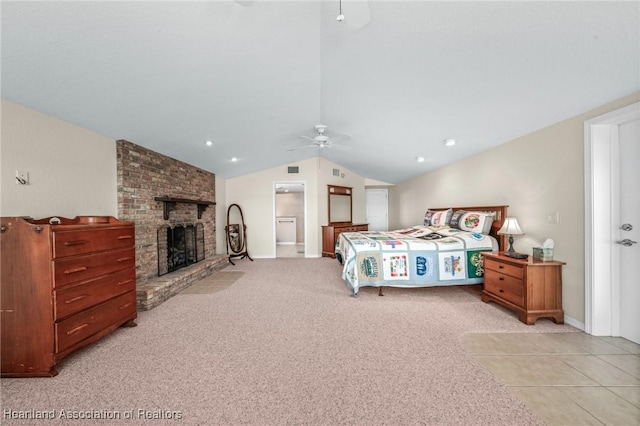 carpeted bedroom featuring a fireplace, ceiling fan, and vaulted ceiling