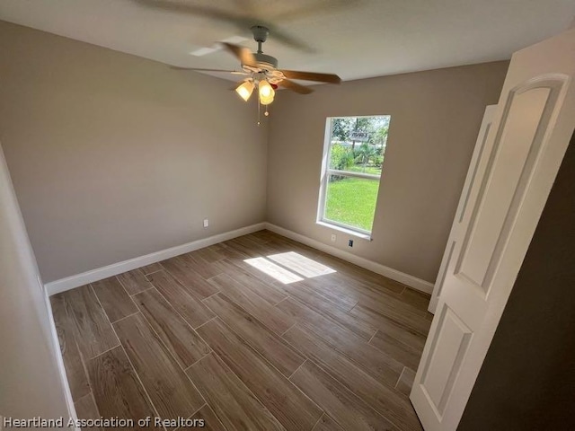 unfurnished room with hardwood / wood-style flooring and ceiling fan