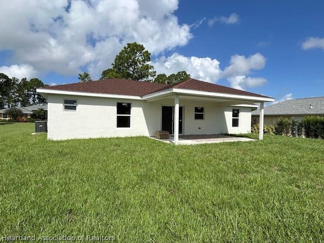 back of property featuring a yard and a patio