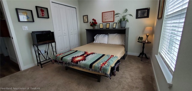 carpeted bedroom featuring a closet