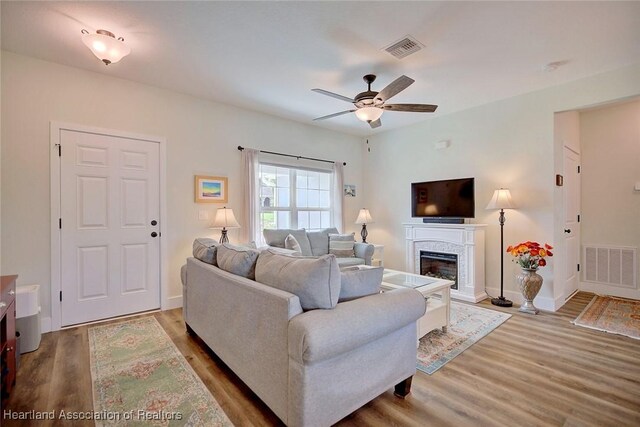 living room with hardwood / wood-style flooring and ceiling fan