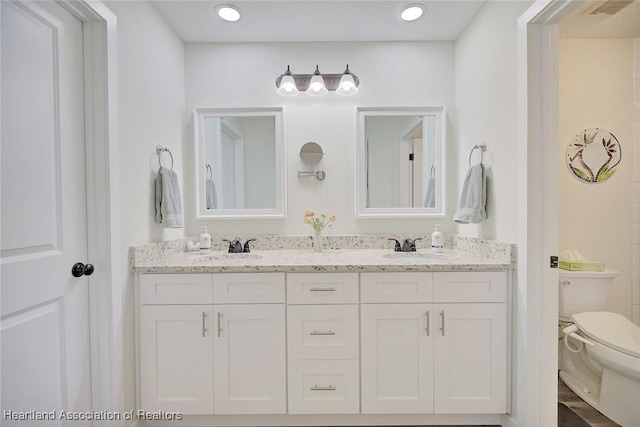 bathroom featuring vanity and toilet