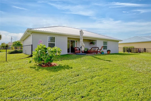 rear view of property featuring a yard