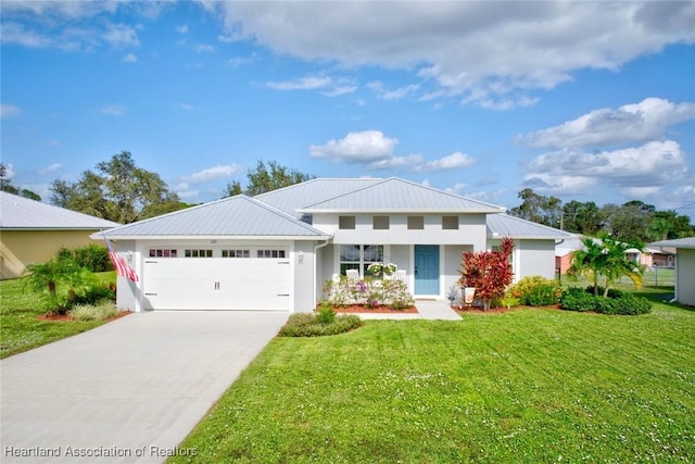 view of front of home with a front yard and a garage