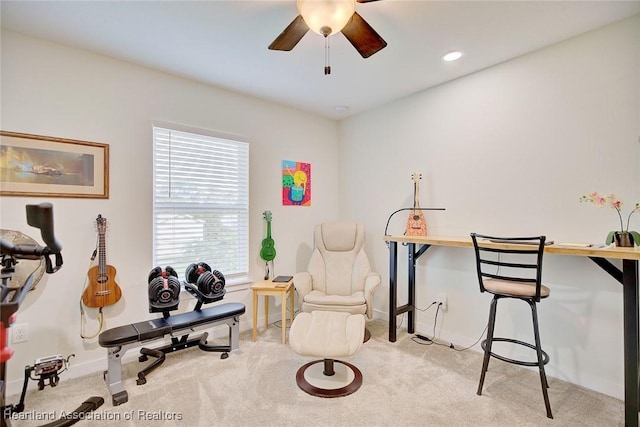 interior space featuring light carpet and ceiling fan