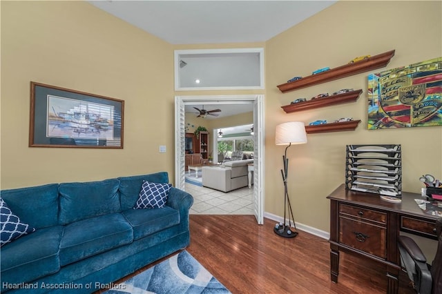 living room with light wood-type flooring and ceiling fan