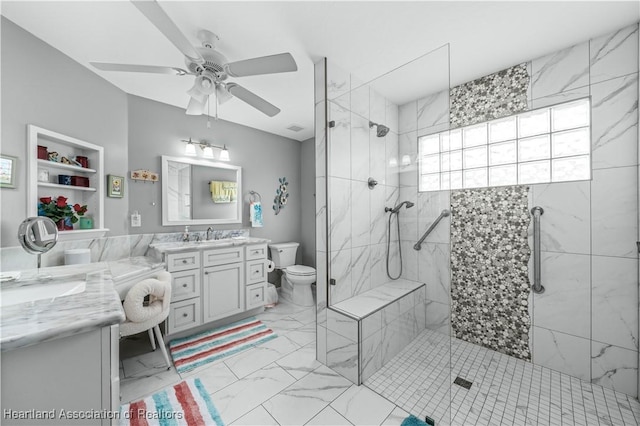 bathroom featuring vanity, toilet, a shower with door, and ceiling fan