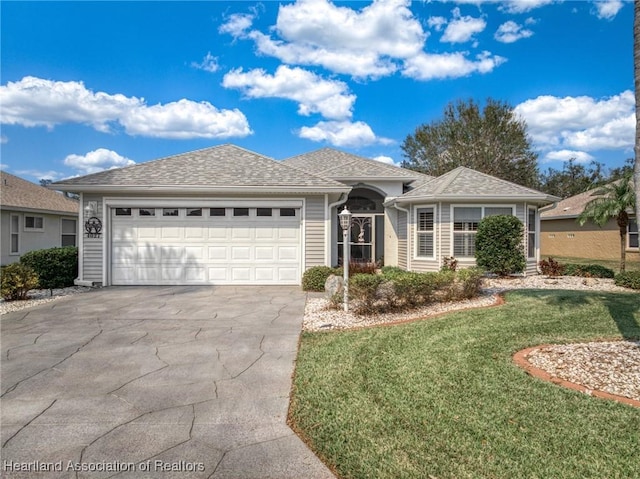 single story home with a garage and a front lawn