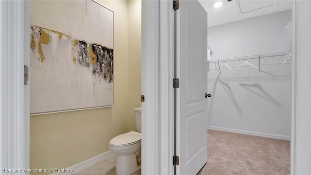 6836 Coconut Dr, Sebring, FL 33872 - bathroom featuring toilet, a walk in closet, and baseboards