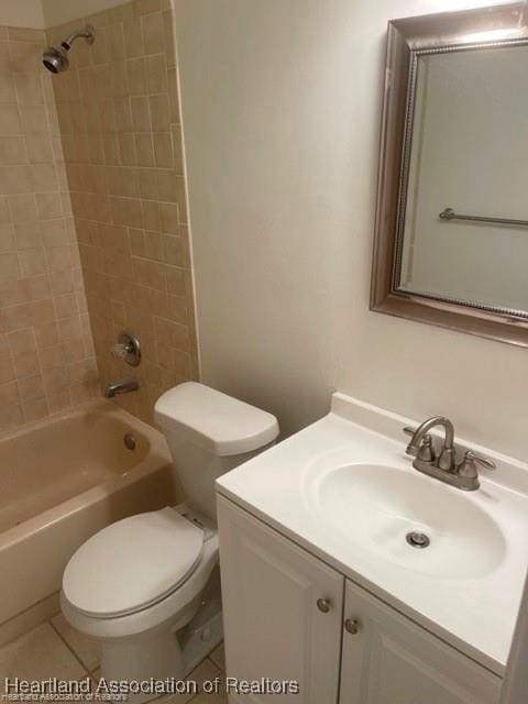 full bathroom featuring vanity, toilet, tiled shower / bath combo, and tile patterned flooring