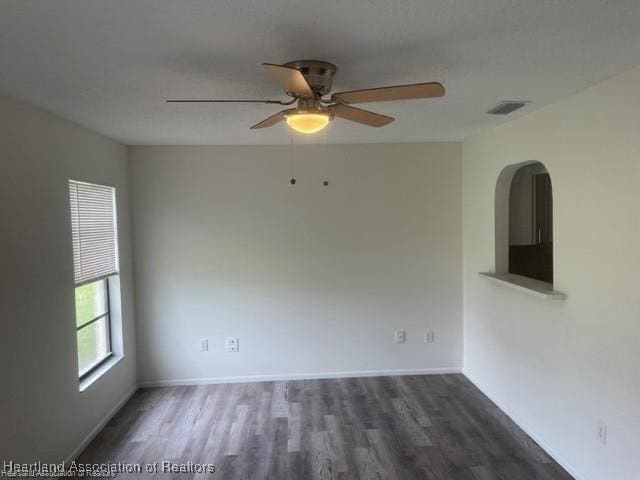 unfurnished room featuring ceiling fan and dark hardwood / wood-style floors