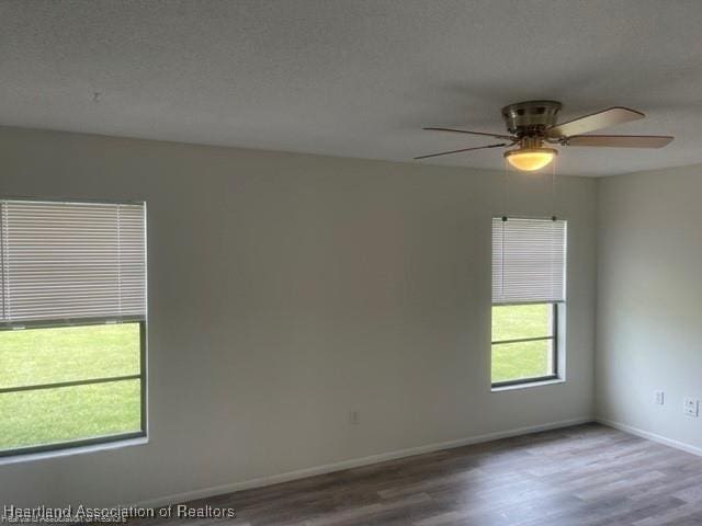 unfurnished room featuring hardwood / wood-style flooring and ceiling fan