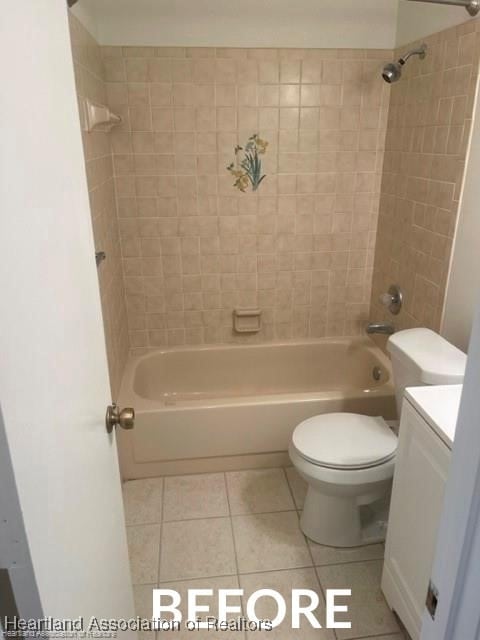 full bath featuring tile patterned flooring, toilet, vanity, and shower / tub combination