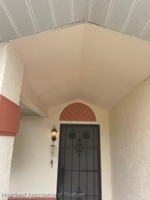 doorway to property featuring stucco siding