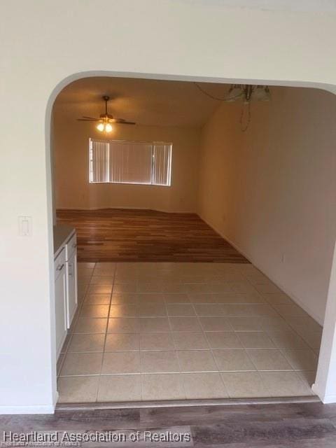 hall featuring light tile patterned floors