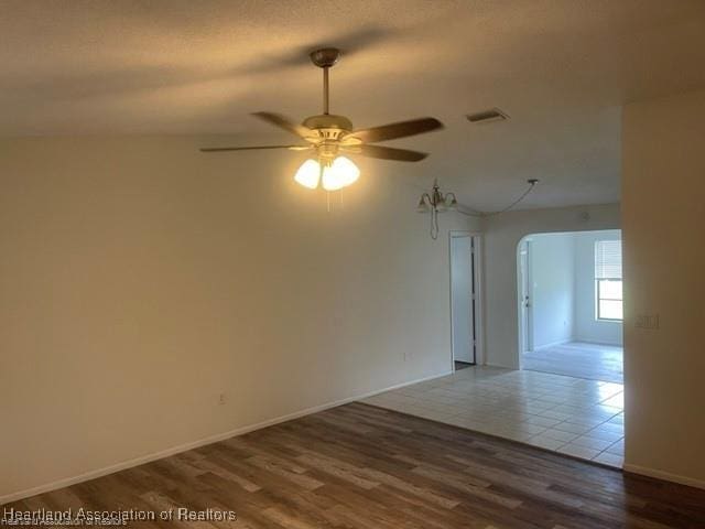 unfurnished room with hardwood / wood-style flooring and ceiling fan