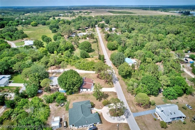 birds eye view of property featuring a forest view