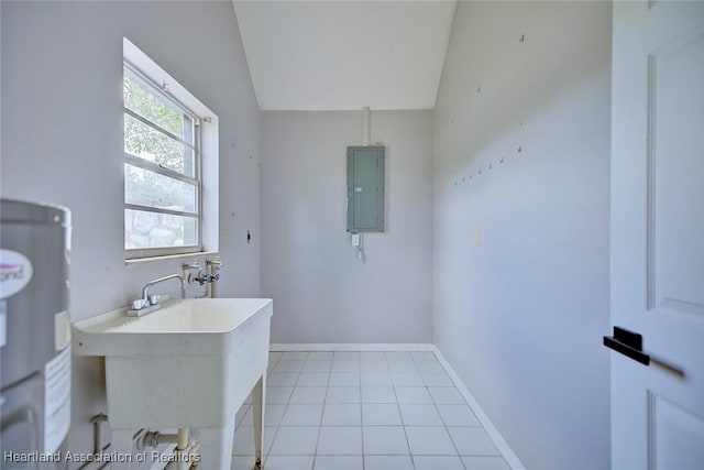 laundry area featuring a sink, electric panel, laundry area, water heater, and baseboards