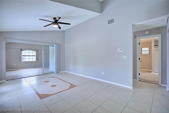 foyer entrance featuring light tile patterned floors, a ceiling fan, visible vents, and vaulted ceiling