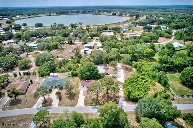 drone / aerial view with a water view and a residential view