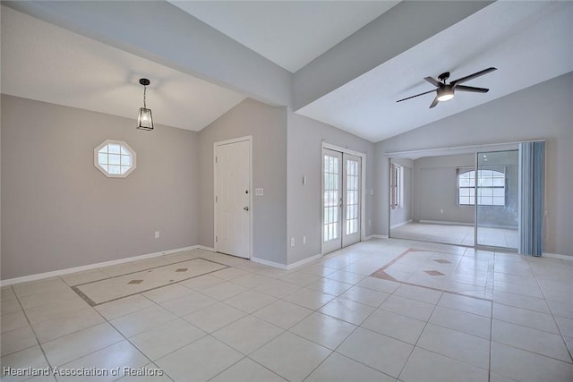 entryway featuring baseboards, light tile patterned floors, ceiling fan, and lofted ceiling