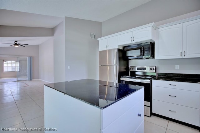 kitchen with dark stone countertops, appliances with stainless steel finishes, visible vents, light tile patterned flooring, and a ceiling fan